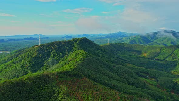 Drone flying over over telecommunication towers on green mountain alt