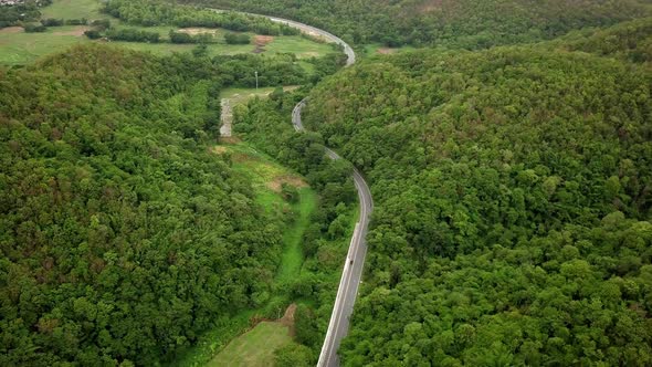 Aerial View Of Countryside Road Passing Through The Mountain Landscape alt