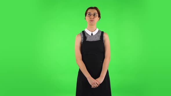 Funny Girl in Round Glasses Is Waiting with Boredom. Green Screen alt