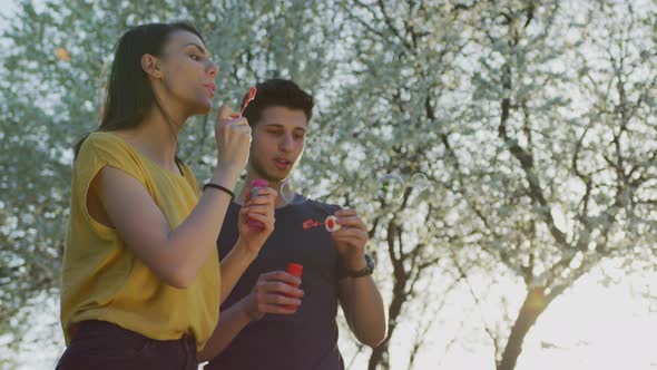 Making soap bubbles in a park alt