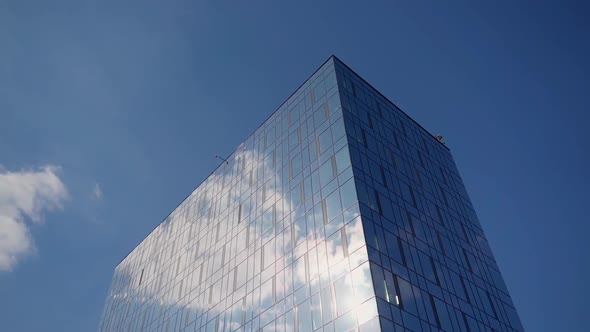 Modern building on sky background. Architecture in the city. Glass construction. Urban tall center alt