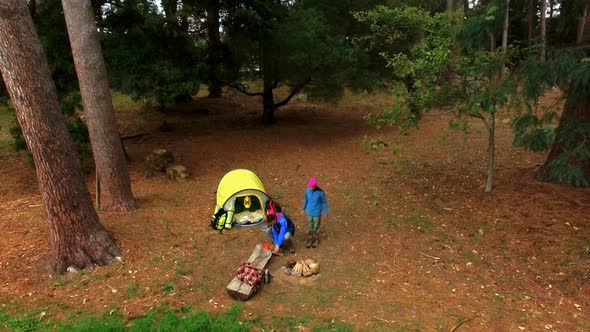 Hiker couple sitting near campfire alt