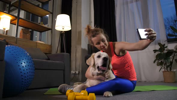Sporty Woman Taking Selfie Photo with Pet Dog alt