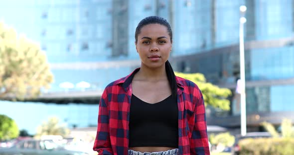 African American girl covers herself with her palm, confidently shows stop and no signs. alt