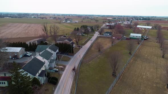 Aerial View of an Open Amish Horse and Buggy Trotting Along alt