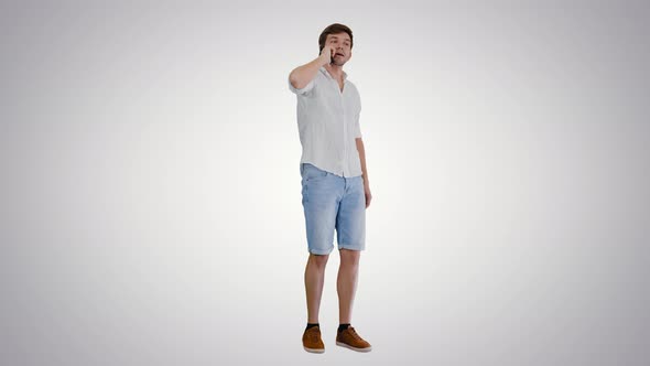 Happy Young Man Talking on Mobile Phone and Smiling on Gradient Background alt