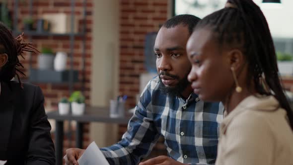 African American Startup Team Working with Statistics Papers on Project alt