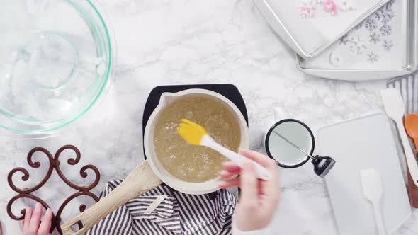 Flat lay. Step by step. Caramelizing sugar in a small cooking pot over the small electric stove alt
