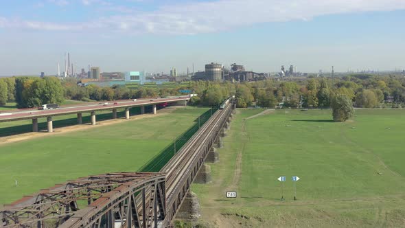 Freight Train Crossing an Iron Bridge Spanning a River alt