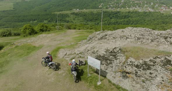 Slow motion aerial shot of the beggining of a ride of two motorcycles. alt