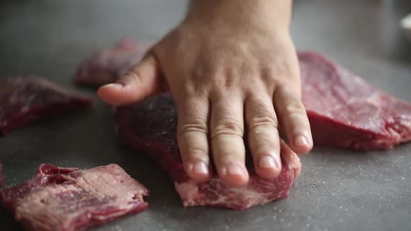 Сhef is slapping fillets for barbecue