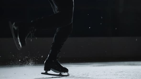 Single Figure Skater Man is Doing Steps Sequence on Ice Rink Closeup of Feet Shod Skates Champion is alt