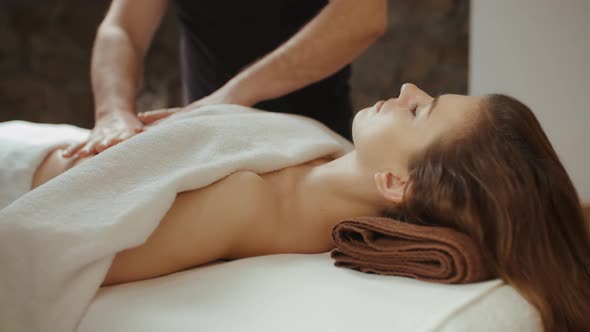 Woman Receiving Stomach Massage in Spa Salon. Male Masseur Hands Burn Fat by Anti Cellulite Massage alt