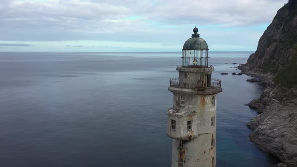 Flying Around a Tower of Lighthouse Aniva on the Rock in Sakhalin Island, Russia.