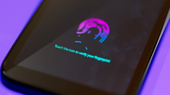 A smartphone displaying on the screen an icon to verify a fingerprint. Security. alt