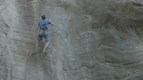 A man rock climbing up a mountain. alt