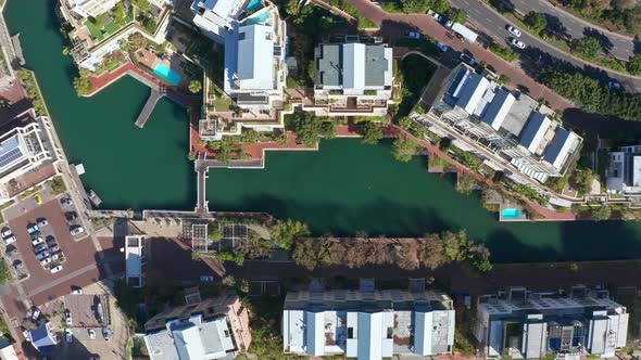 Top down aerial view of the blue marina canal and its geometric lines