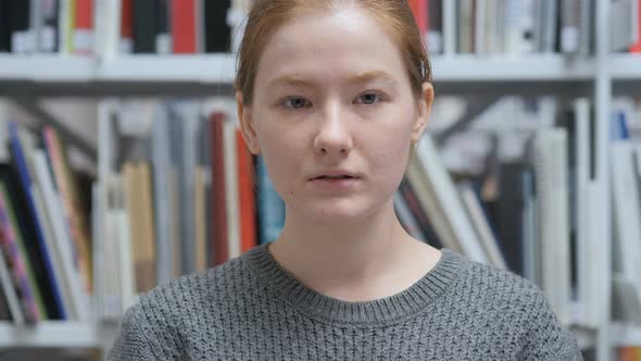 Portrait of Serious Young Female Sitting and Relaxing alt