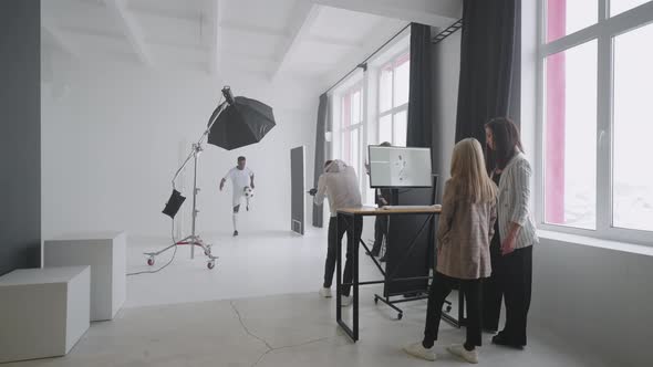 Photo Session for Sport Magazine Team is Photographing Professional Football Player in Studio alt