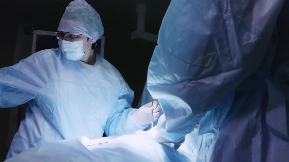 Female doctor in operating room with surgical tools