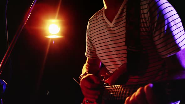 Man singing song while playing electric guitar 4k alt