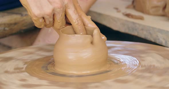 Hands Forming Clay Pot On The Pottery Wheel alt