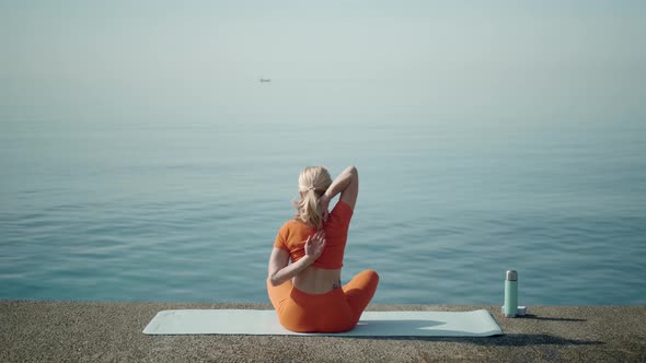 Woman in a Lotus Position with Back to the Camera