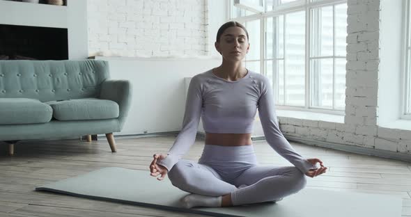 Young Happy Woman Practicing Yoga and Doing Breathing Exercises alt