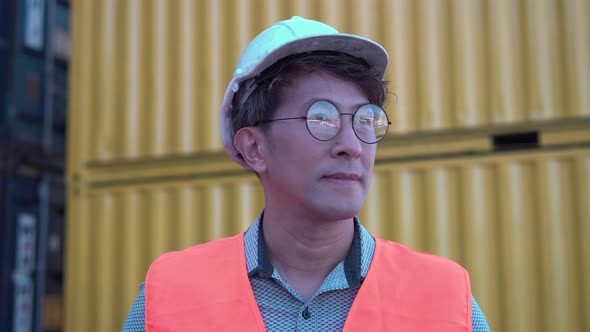 Smiling man looking at camera, Cheerful factory worker man in hard hat, Happy man at cargo container
