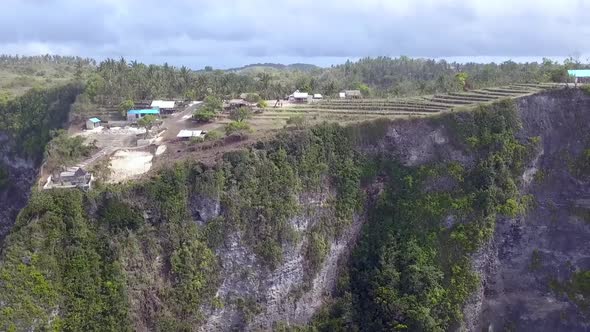 Daring aerial view flight slowly tilt down drone flight of Untouched danger nature Kelingking Beach alt