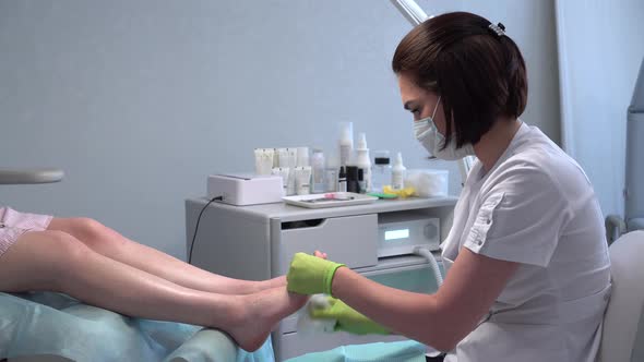 Padologist Prepares the Legs for the Procedure alt