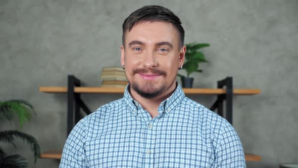 Close up smiling businessman CEO standing in office turns head looking camera alt