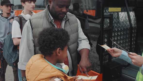 Female Bus Conductor Scanning Passengers Tickets alt