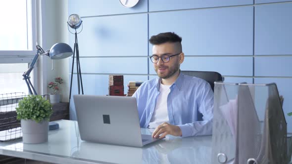 Man Person Using Video Conferencing technology in Home Office for video call with colleagues alt