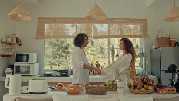 Young Happy Active Married Couple Dancing Laughing Together Cooking Meals at Home Carefree Joyful alt