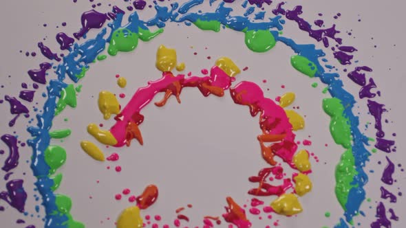 Various Colors Dripped Onto A White Background alt