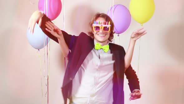 Slow motion of cheerful couple dancing funny in photo booth alt