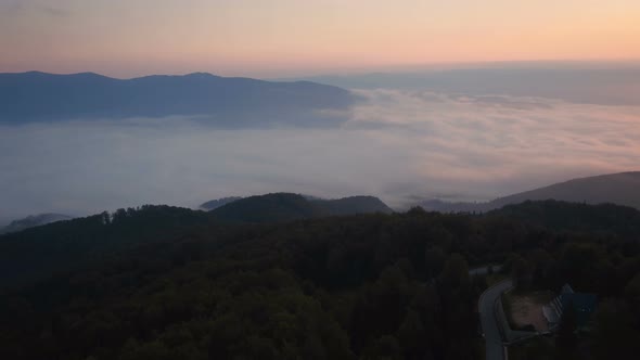 Aerial view of a foggy valley at sunset alt