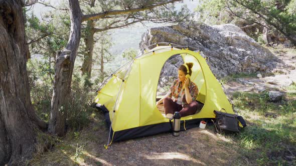 Young Woman in Headphones Relax in Tent at Nature