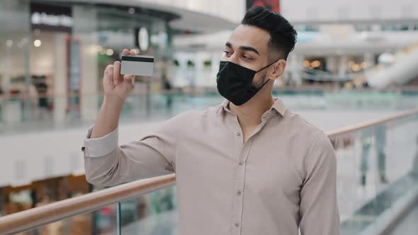 Arabian Indian Hispanic Man in Medical Mask Standing with Purchases alt