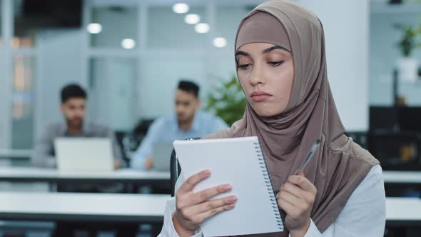Thoughtful Millennial Indian Woman in Hijab Looking Aside Planning Preparing for Meeting alt