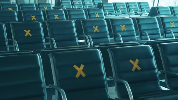Airport Seats Marked with Crosses for Social Distancing alt