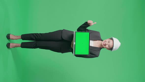Full Body Of Female Engineer With Green Screen Laptop Showing Thumbs Up In The Green Screen Studio alt