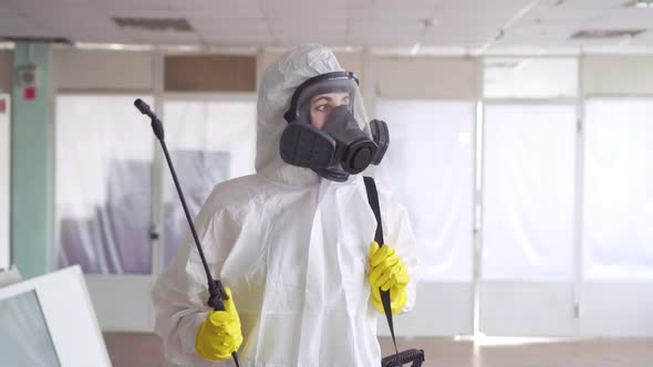 Portrait of the Exterminator in Overalls with a Sprayer alt
