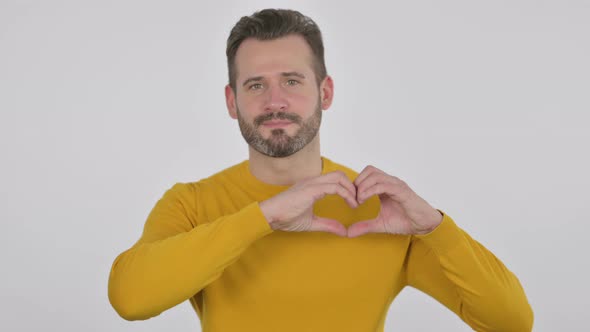 Portrait of Middle Aged Man Showing Heart Shape By Hands alt