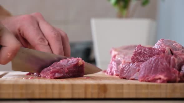 Man Cuts Meat with Knife on Wooden Board Preparation Minced Beef Pork for Cutlets Meatballs Chops