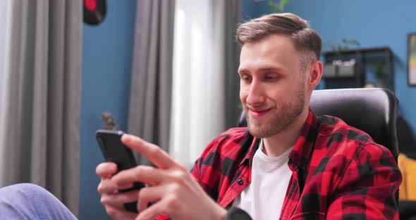 Portrait of Teenage Student Boy Sitting Comfortably on a Chair in His Room alt