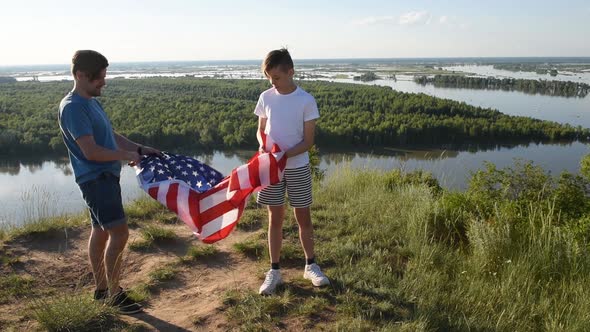 Cute Young Boy and His Father Holding Aloft the American Flag