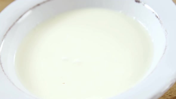 Strawberry falling in whipped cream alt