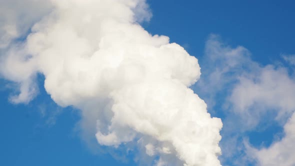 The smoke from the chimney of the industrial plant.